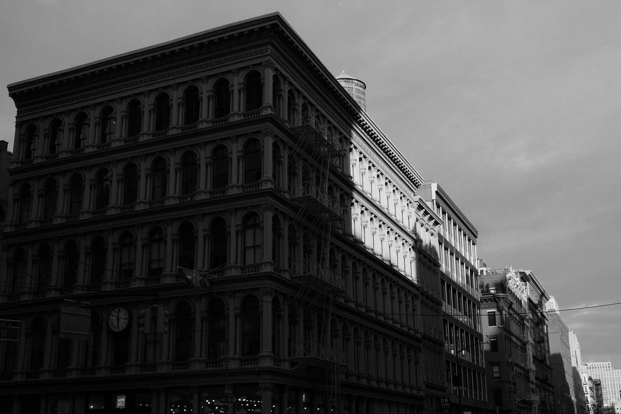 Black-and-white cast-iron building divided by sunlight