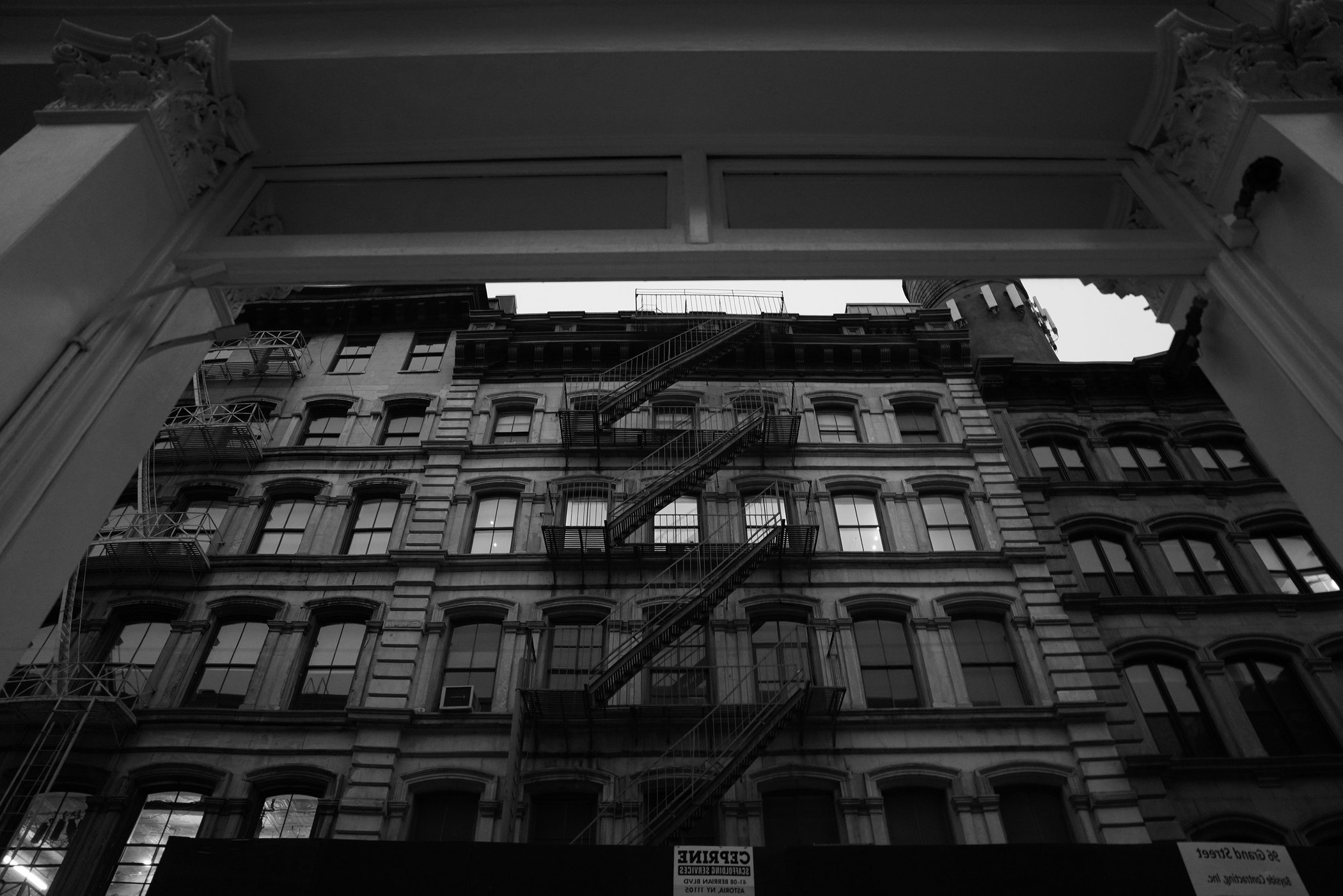 Black-and-white fire escape framed by an architectural opening