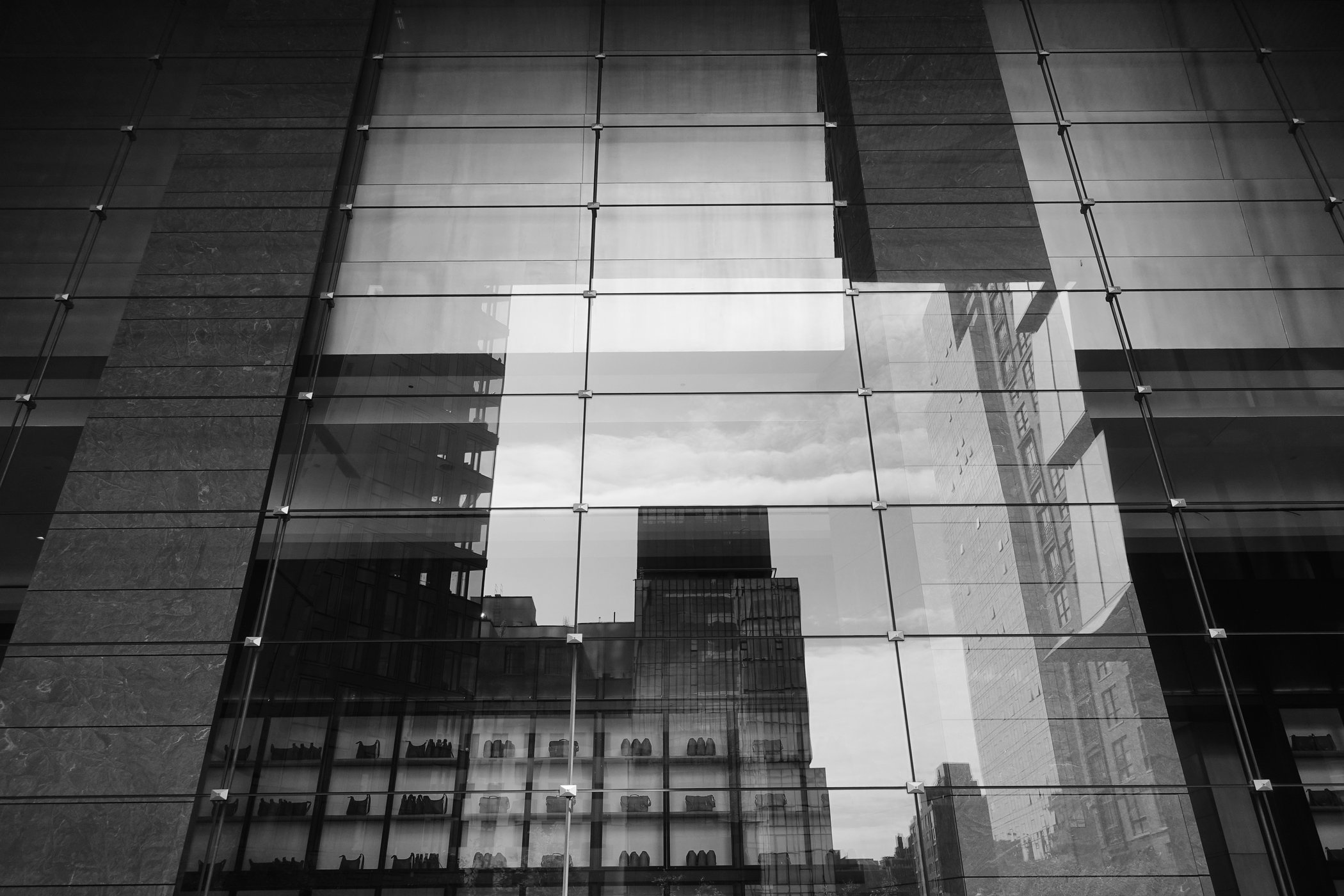 Multiple buildings layered across a glass facade
