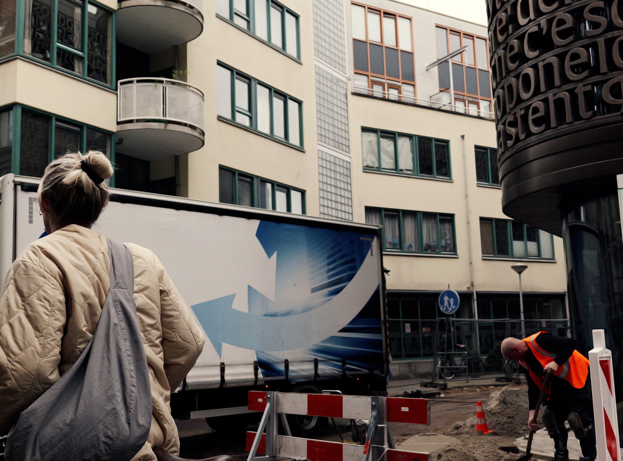 Street construction scene with graphic forms and pedestrians