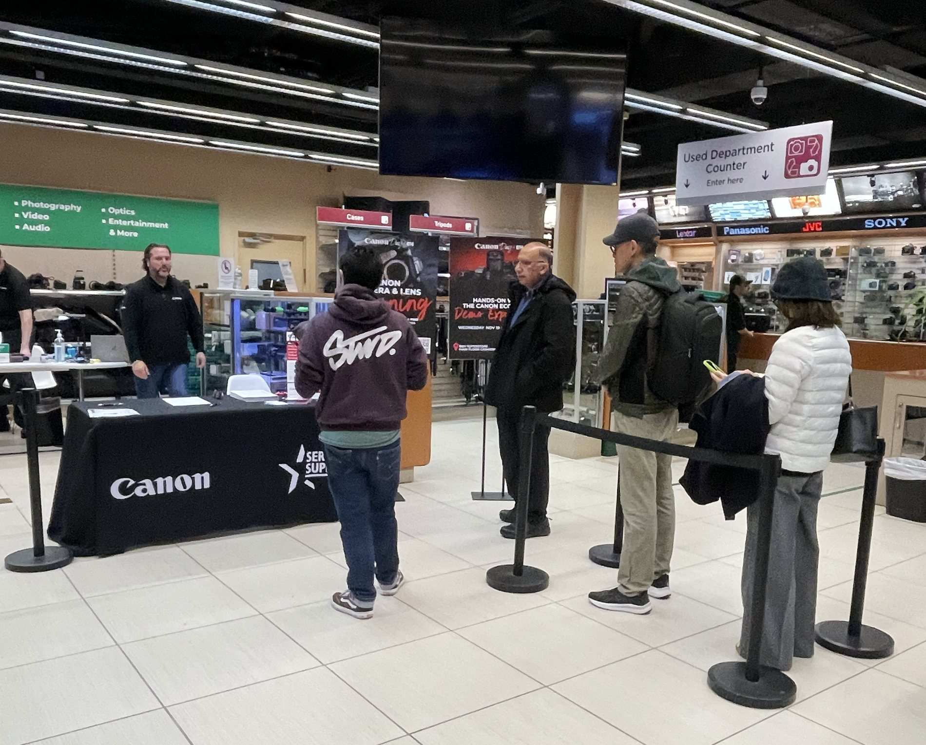 Customers waiting for complimentary Canon camera and lens cleaning